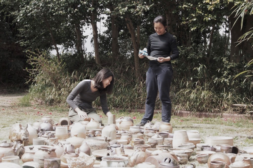 Shao Qi and Jaslin working on their ceramics artworks